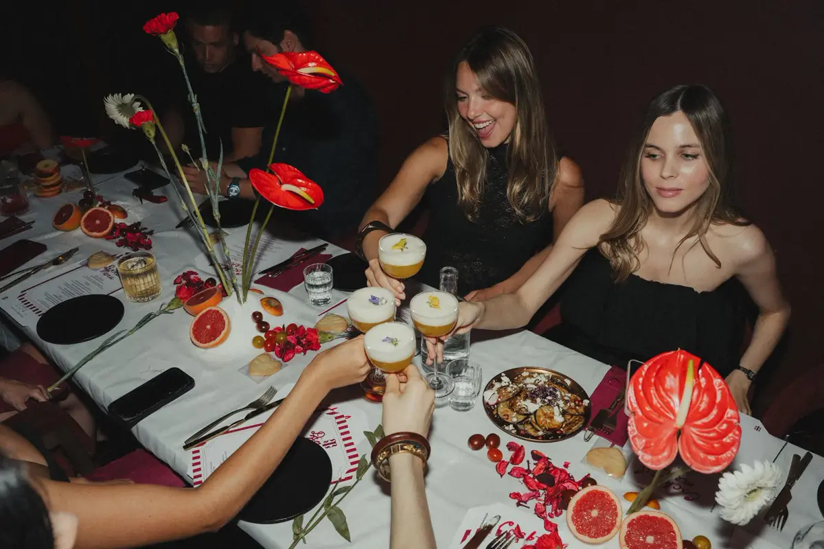 Friends toasting signature cocktails at Patara