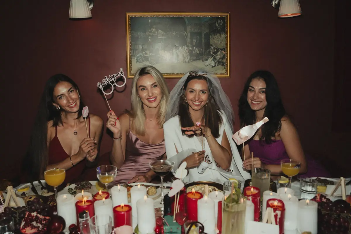Friends toasting around the table at Patara