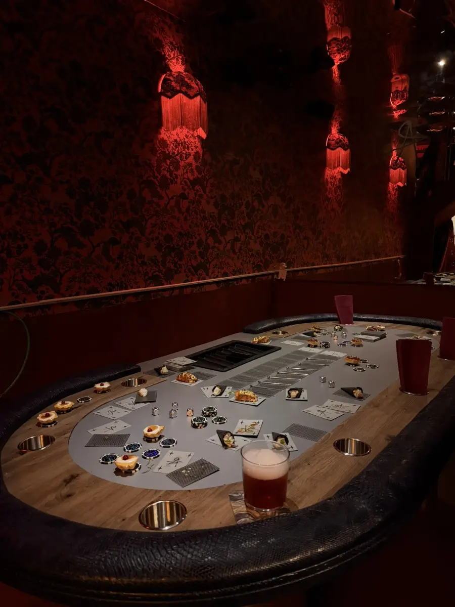 Canapés and cocktail chips laid out across the poker table for a private event